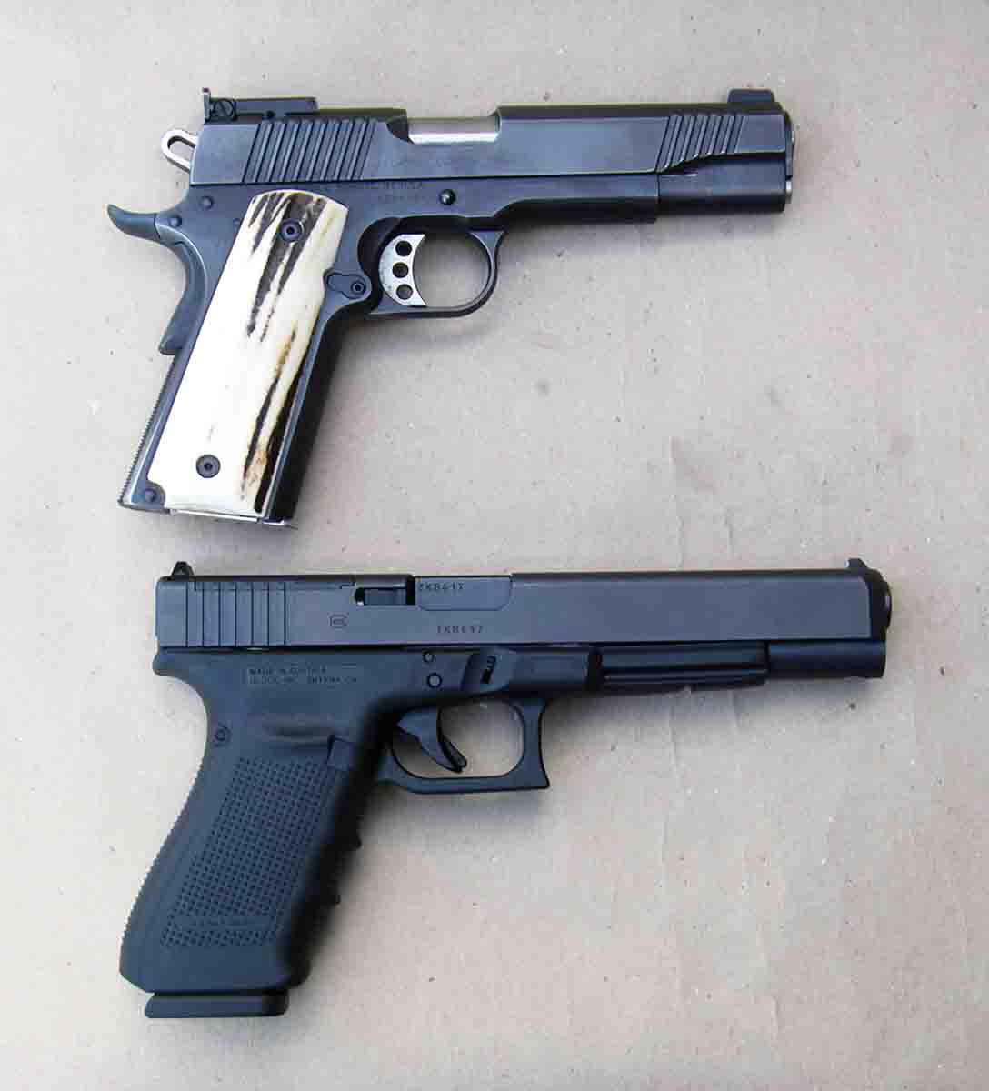 The G40 Gen4 MOS (bottom) is a large pistol. For comparison, it is shown next to a Kimber Model 1911.